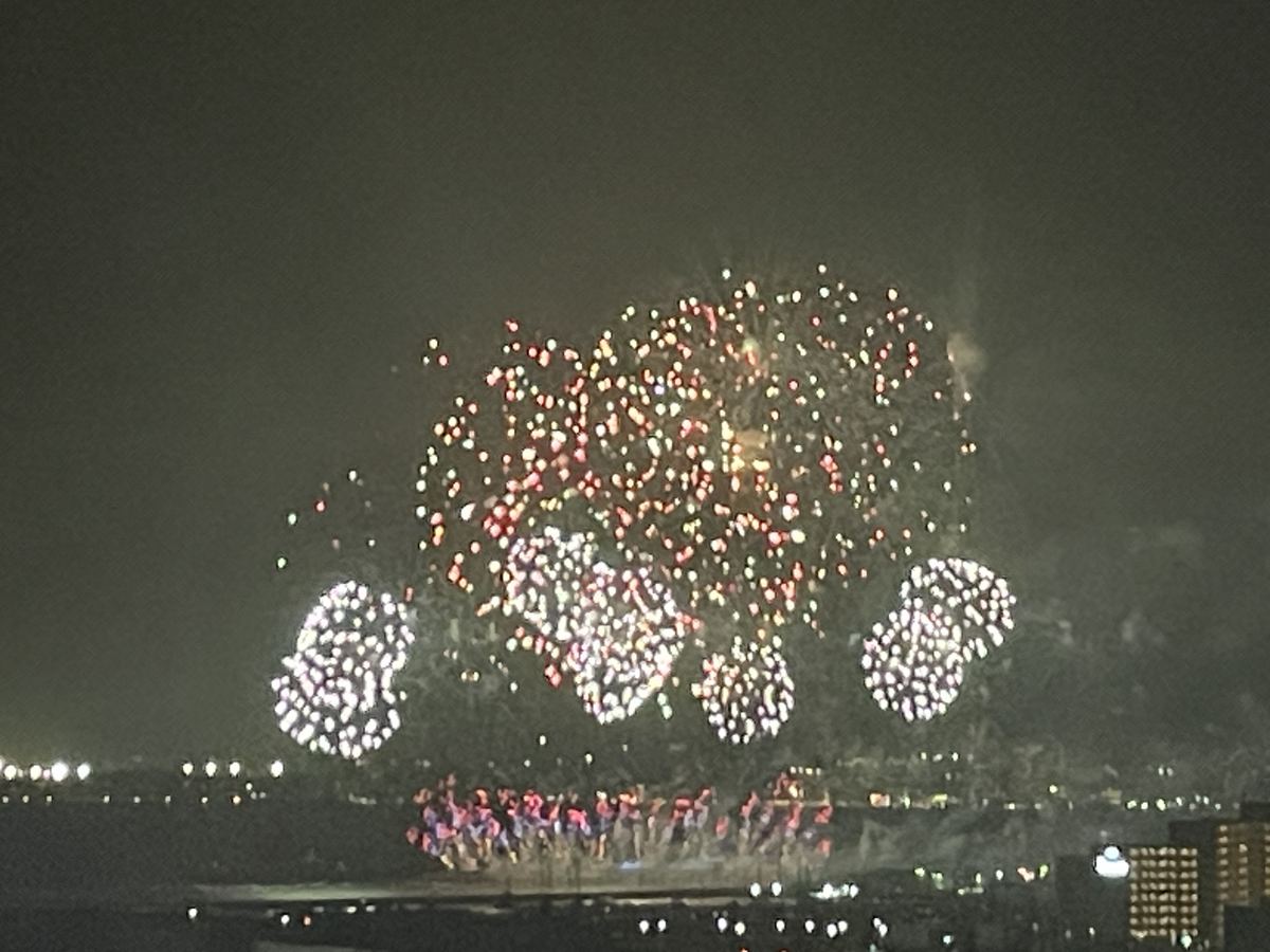 沖縄かなさ花火 遠くに上がる白と赤の花火